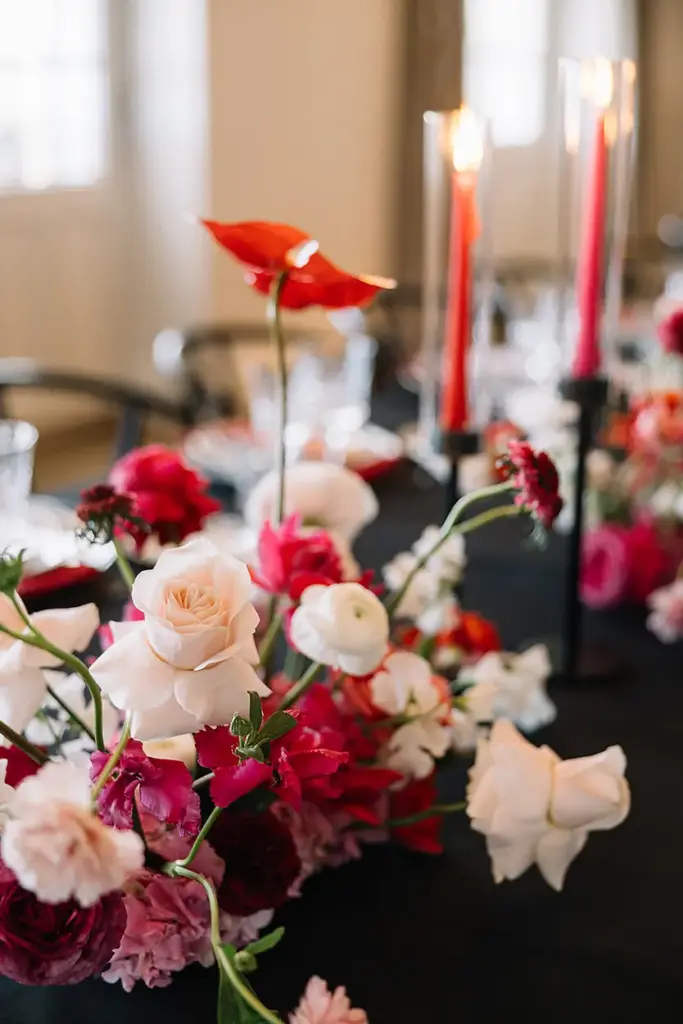 Moderne Blumenarrangements in Pink auf schwarzem Tisch bei einem privaten Event in einer Villa in Hamburg